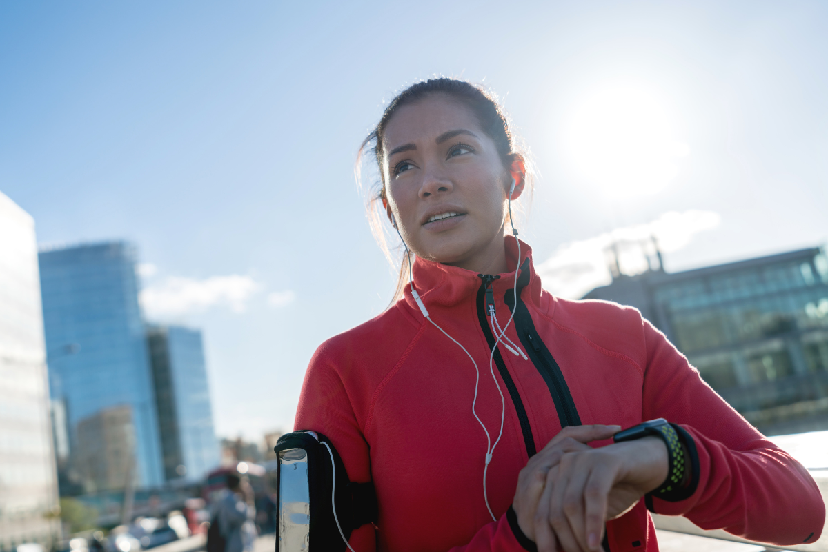 Female runner using wearable technology outdoors