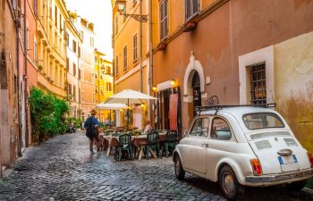 Street scene in Rome with cafe and car