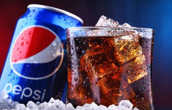 Pepsi can and soda in icy glass
