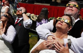 More than 300 couples exchange vows during total solar eclipse wedding