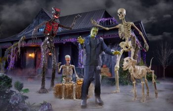 a yard with halloween decorations including skeleton figures